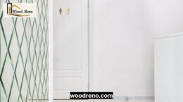 White door installed beside a tiled bathroom entrance